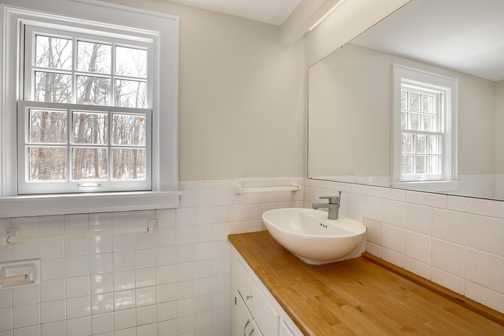 211 Pope Road Acton, MA 01742 - Photo 18 of 29 a bathroom with a sink and a window