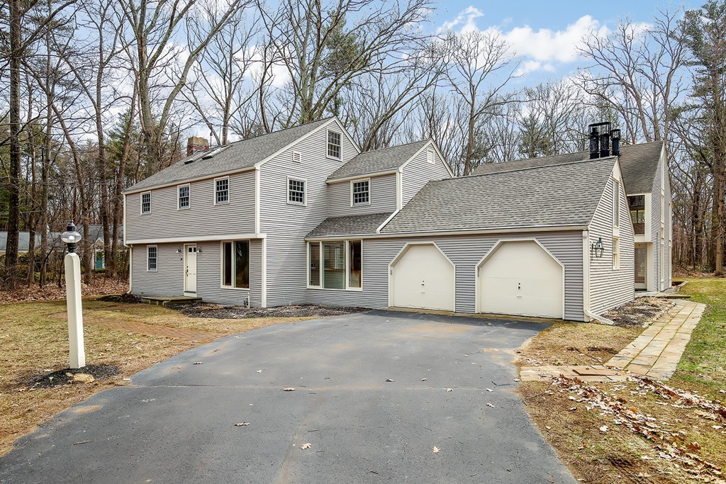 211 Pope Road Acton, MA 01742 - Photo 24 of 29 a front view of a house with a dirt yard