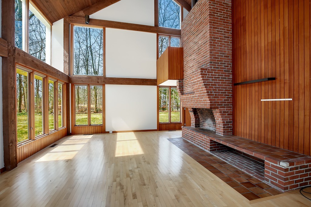 211 Pope Road Acton, MA 01742 - Photo 3 of 29 a view of an empty room with wooden floor and a window