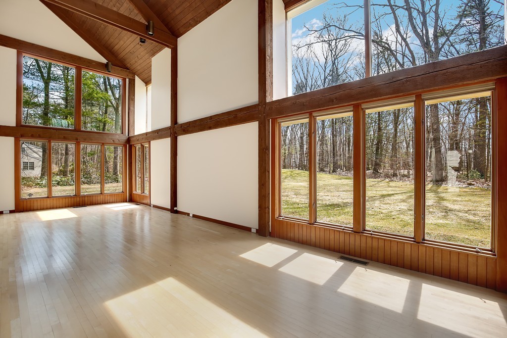211 Pope Road Acton, MA 01742 - Photo 4 of 29 a view of an empty room with wooden floor and a window