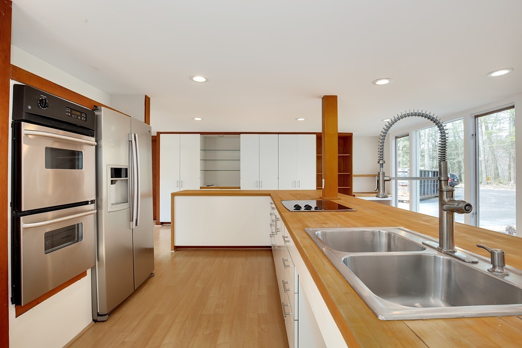 211 Pope Road Acton, MA 01742 - Photo 7 of 29 a kitchen with stainless steel appliances granite countertop a sink and a refrigerator