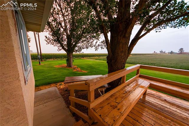 1027 County Road LL Fowler, CO 81039 - Photo 33 of 37 Wooden terrace with a rural view and a yard