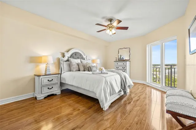 a bedroom with a large bed and a chandelier