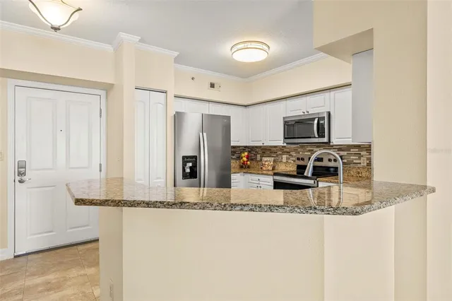 a kitchen with granite countertop a sink and cabinets