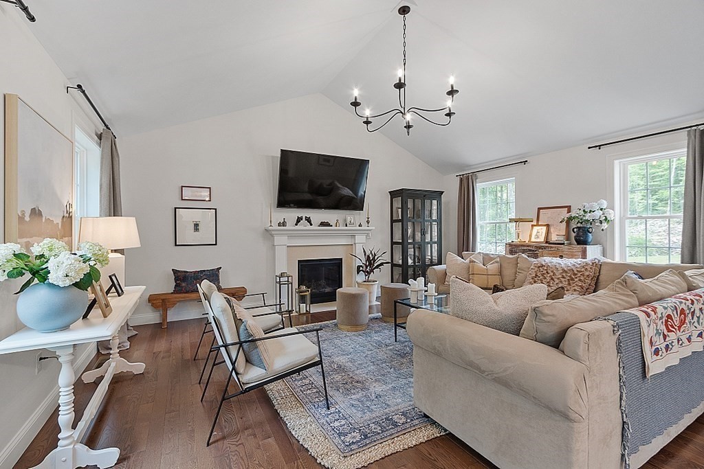 83 Russell Hill Road Brookline, NH 03033 - Photo 12 of 42 a living room with furniture a fireplace and a flat screen tv