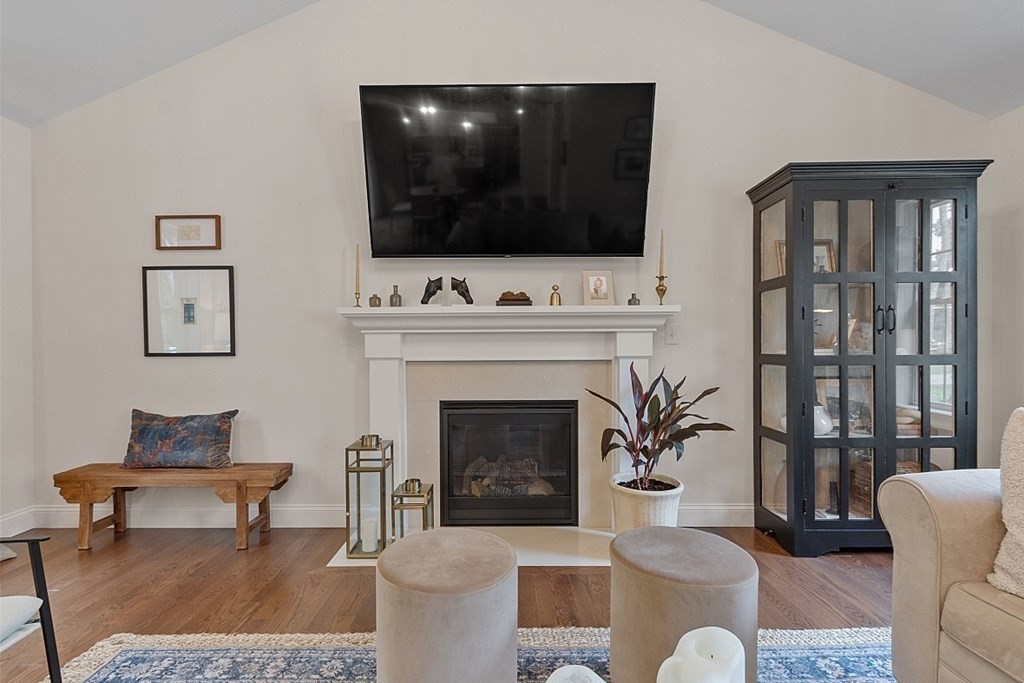 83 Russell Hill Road Brookline, NH 03033 - Photo 13 of 42 a living room with furniture a fireplace and a flat screen tv