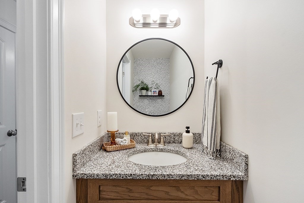 83 Russell Hill Road Brookline, NH 03033 - Photo 17 of 42 a bathroom with a granite countertop double vanity and a mirror