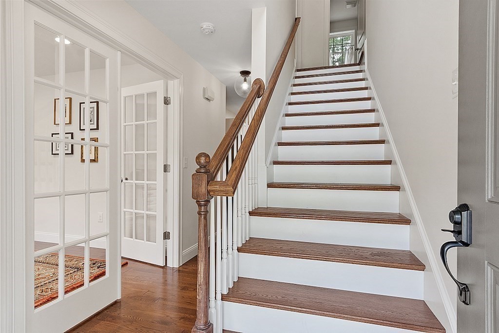 83 Russell Hill Road Brookline, NH 03033 - Photo 21 of 42 a view of staircase with lots of frames on wall and a window