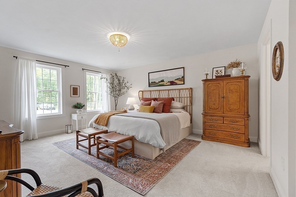 83 Russell Hill Road Brookline, NH 03033 - Photo 22 of 42 a bedroom with a bed a table and chair