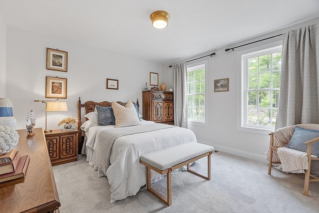 83 Russell Hill Road Brookline, NH 03033 - Photo 27 of 42 a spacious bedroom with a bed and a window