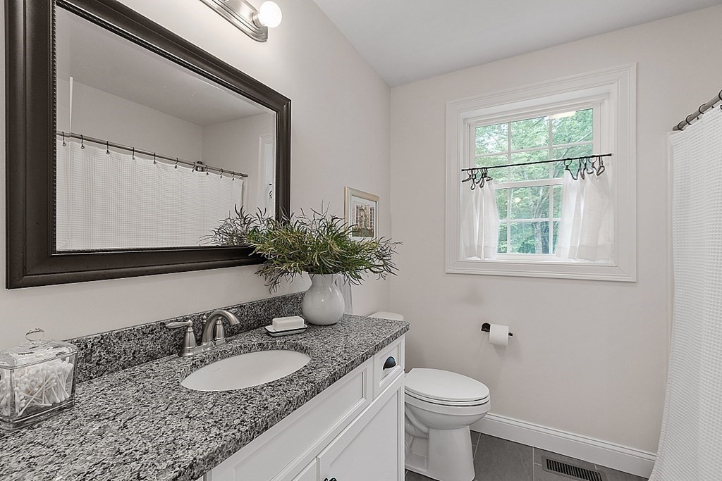 83 Russell Hill Road Brookline, NH 03033 - Photo 29 of 42 a bathroom with a granite countertop sink toilet and mirror