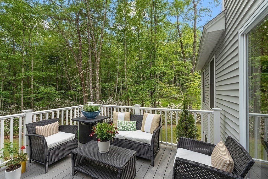 83 Russell Hill Road Brookline, NH 03033 - Photo 32 of 42 a view of a chair and table on the deck
