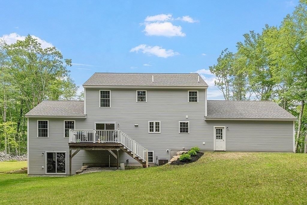 83 Russell Hill Road Brookline, NH 03033 - Photo 33 of 42 a front view of a house with a garden and plants
