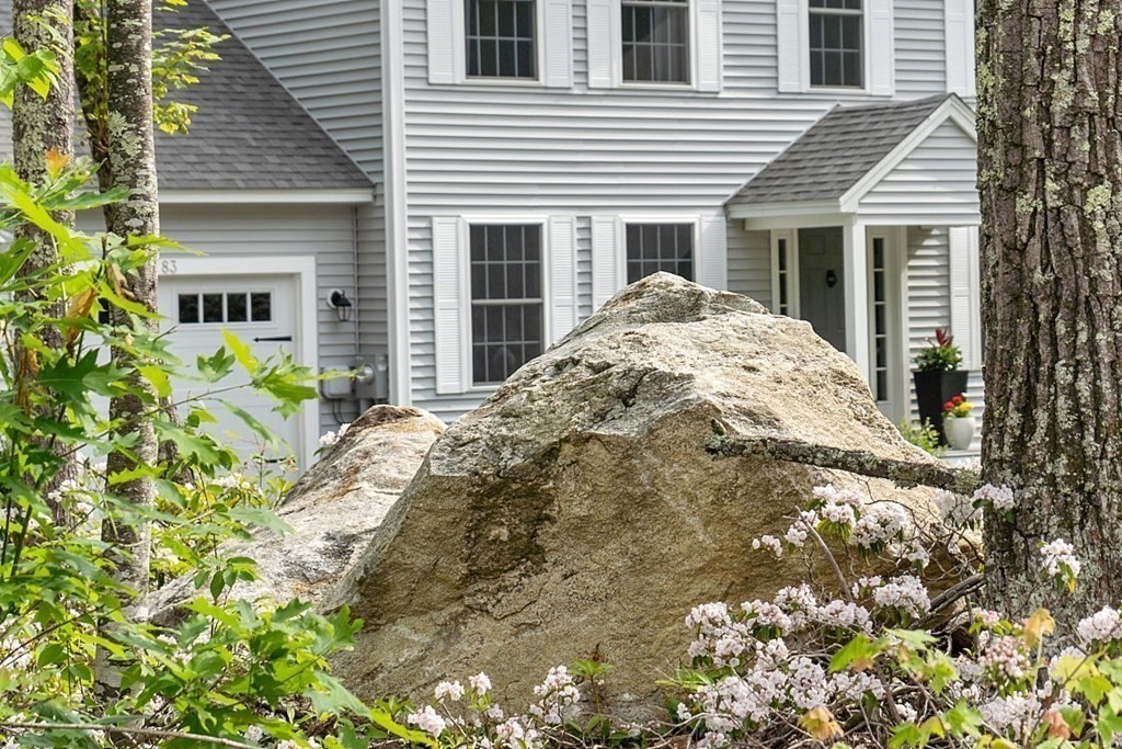 83 Russell Hill Road Brookline, NH 03033 - Photo 4 of 42 a front view of a house with a garden