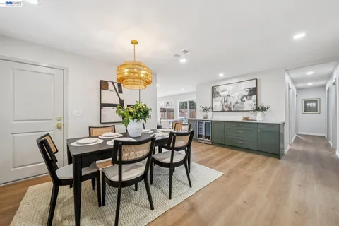 a dining room with furniture and chandelier