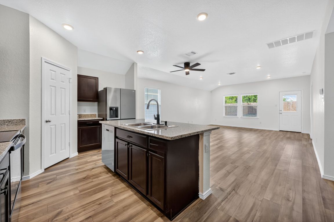 596 Wyatt Way Jarrell, TX 76537 - Photo 21 of 21 a kitchen with stainless steel appliances granite countertop a sink stove and refrigerator