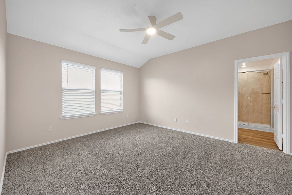 596 Wyatt Way Jarrell, TX 76537 - Photo 11 of 21 an empty room with windows and fan