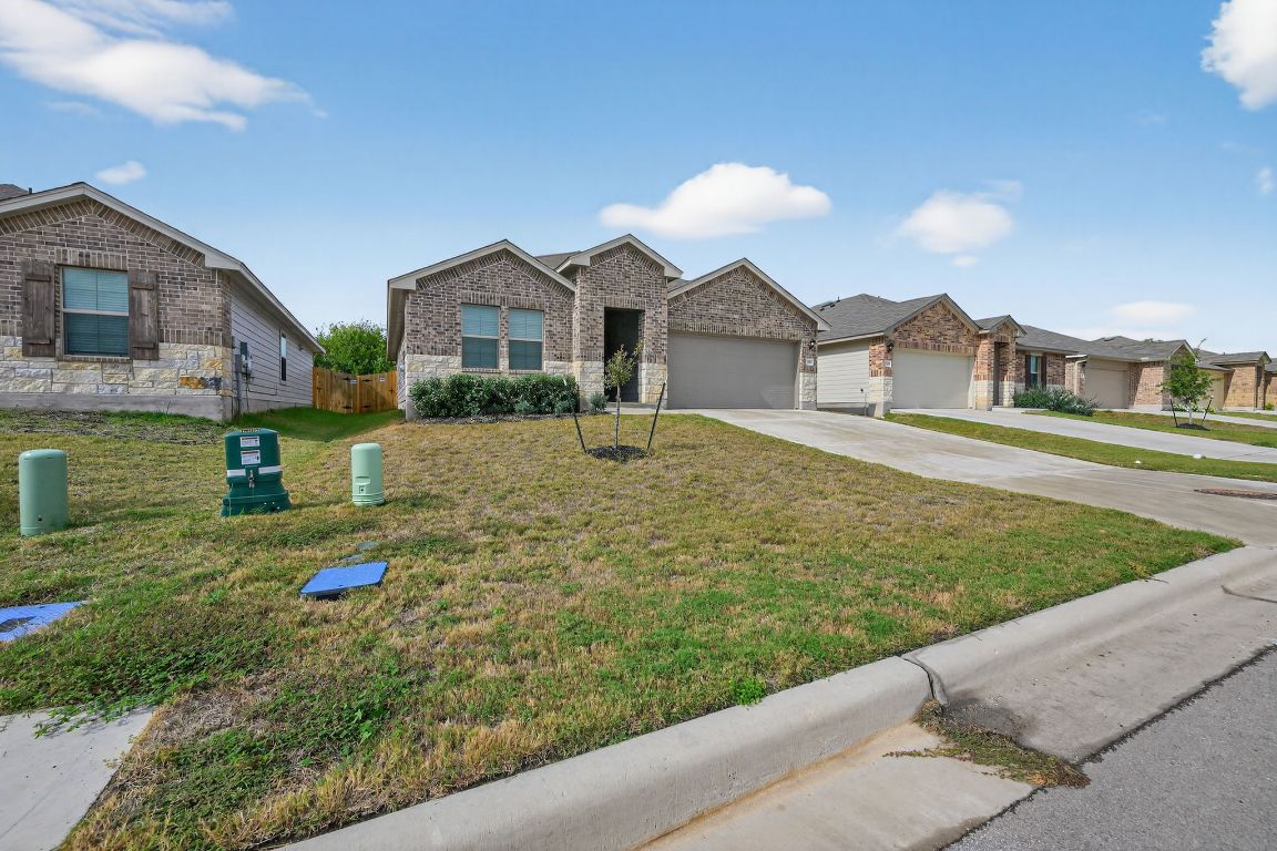 596 Wyatt Way Jarrell, TX 76537 - Photo 3 of 21 a front view of a house with a yard and garage