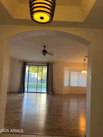 a view of a room has wooden floor and window