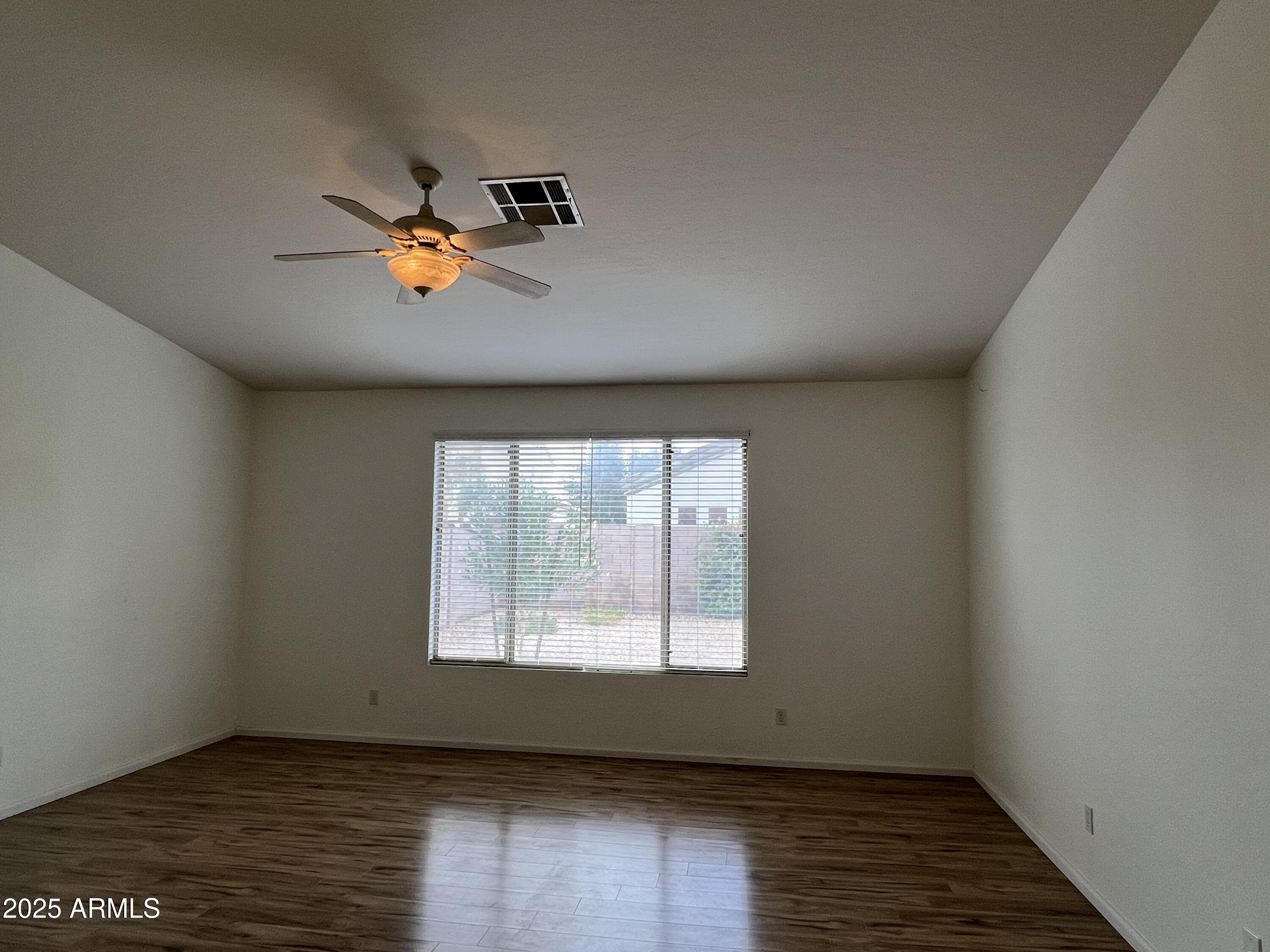 4484 East Redfield Court Gilbert, AZ 85234 - Photo 20 of 25 an empty room with a window and wooden floor