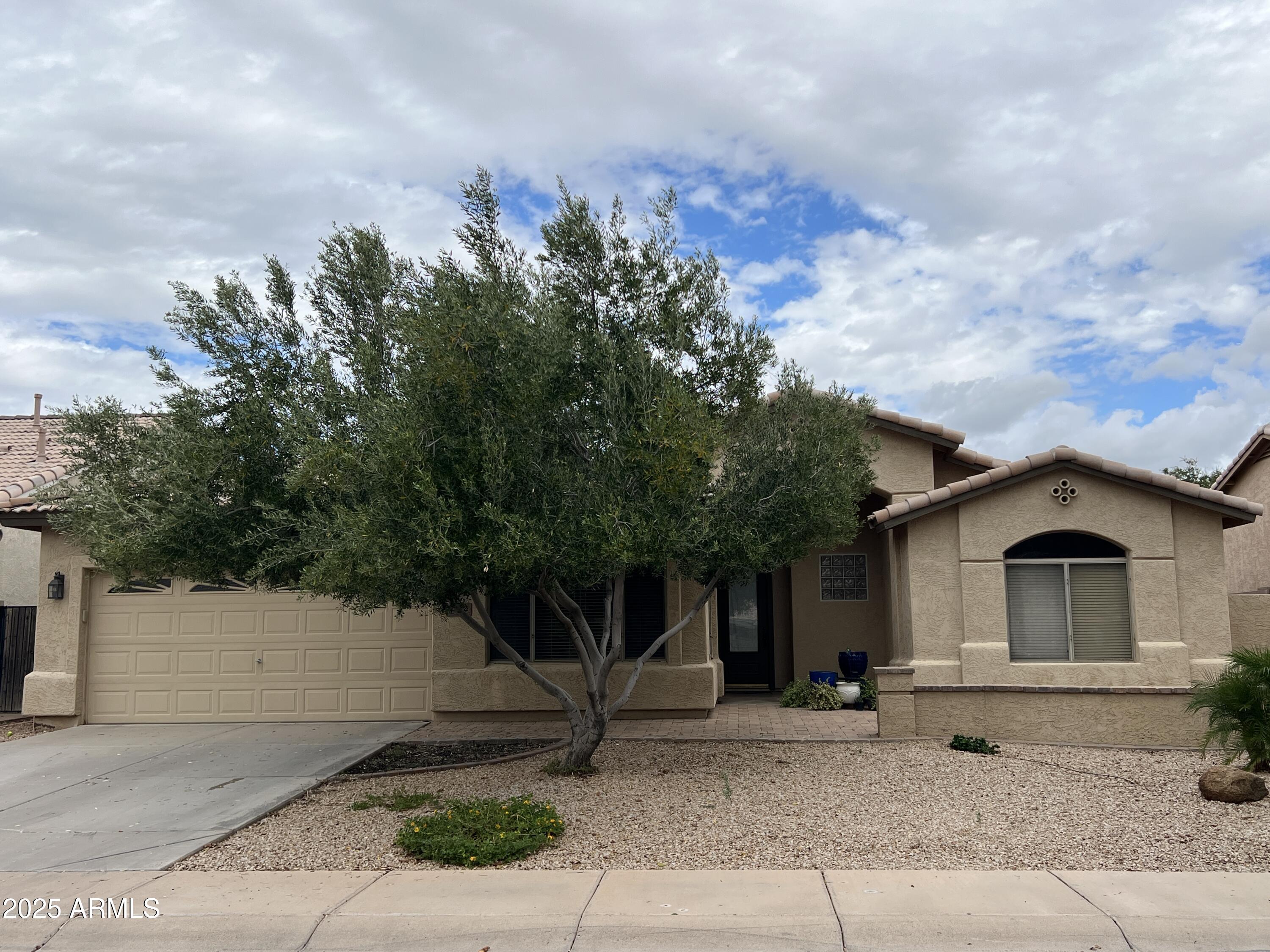 4484 East Redfield Court Gilbert, AZ 85234 - Photo 23 of 25 a front view of a house with a garden