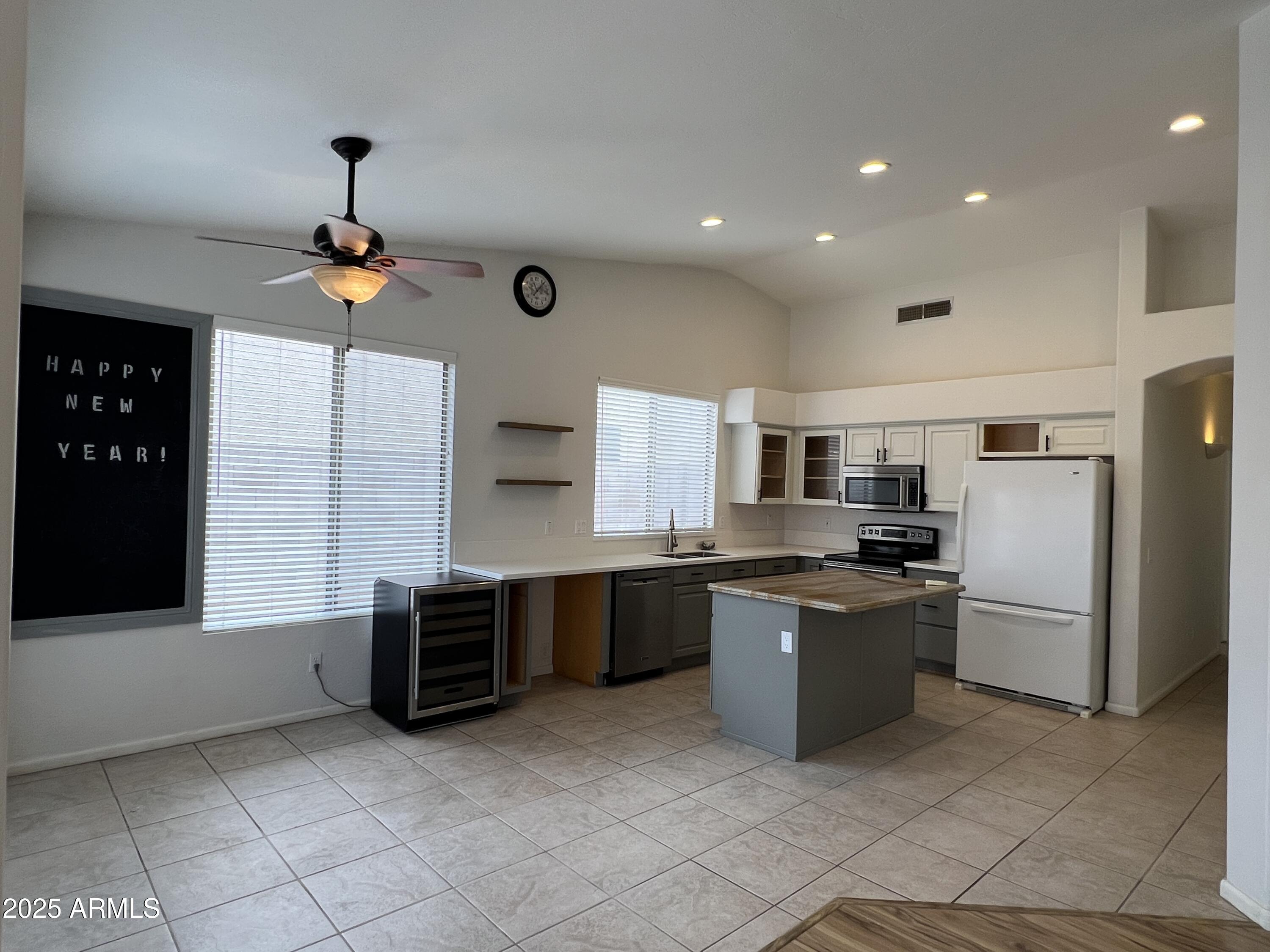 4484 East Redfield Court Gilbert, AZ 85234 - Photo 4 of 25 a kitchen with stainless steel appliances granite countertop a stove top oven a sink dishwasher a refrigerator and a refrigerator