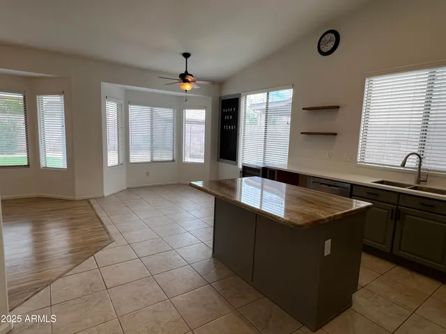 a view of a kitchen with granite countertop a sink and a stove