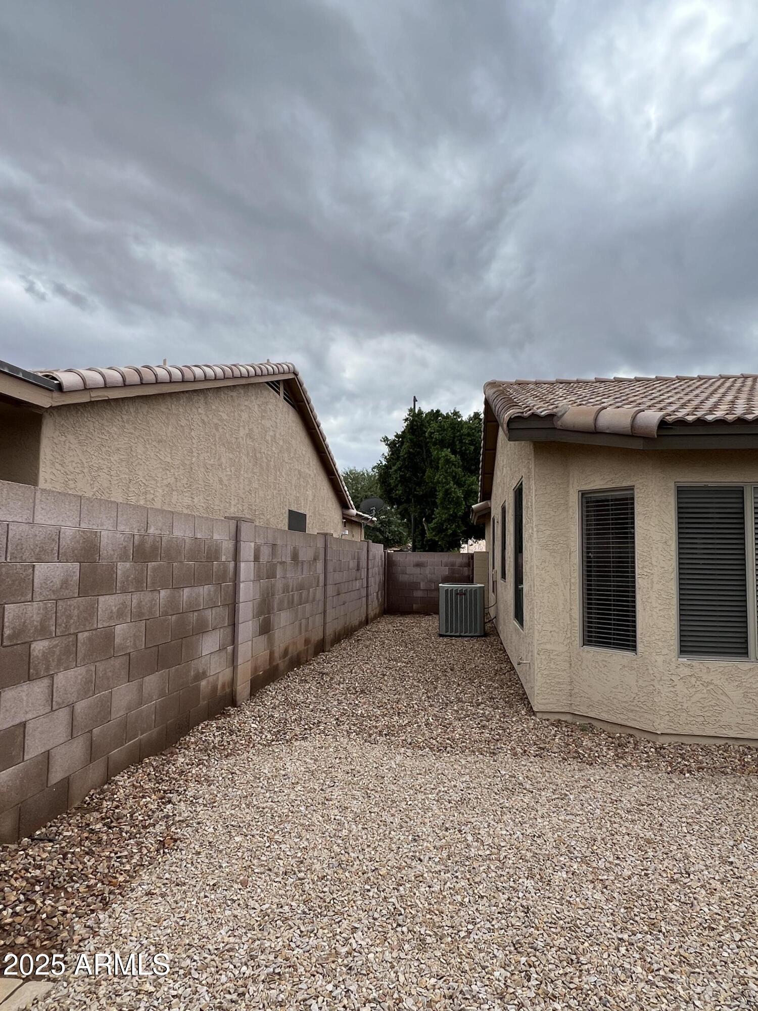 4484 East Redfield Court Gilbert, AZ 85234 - Photo 8 of 25 a view of a house with a wooden fence