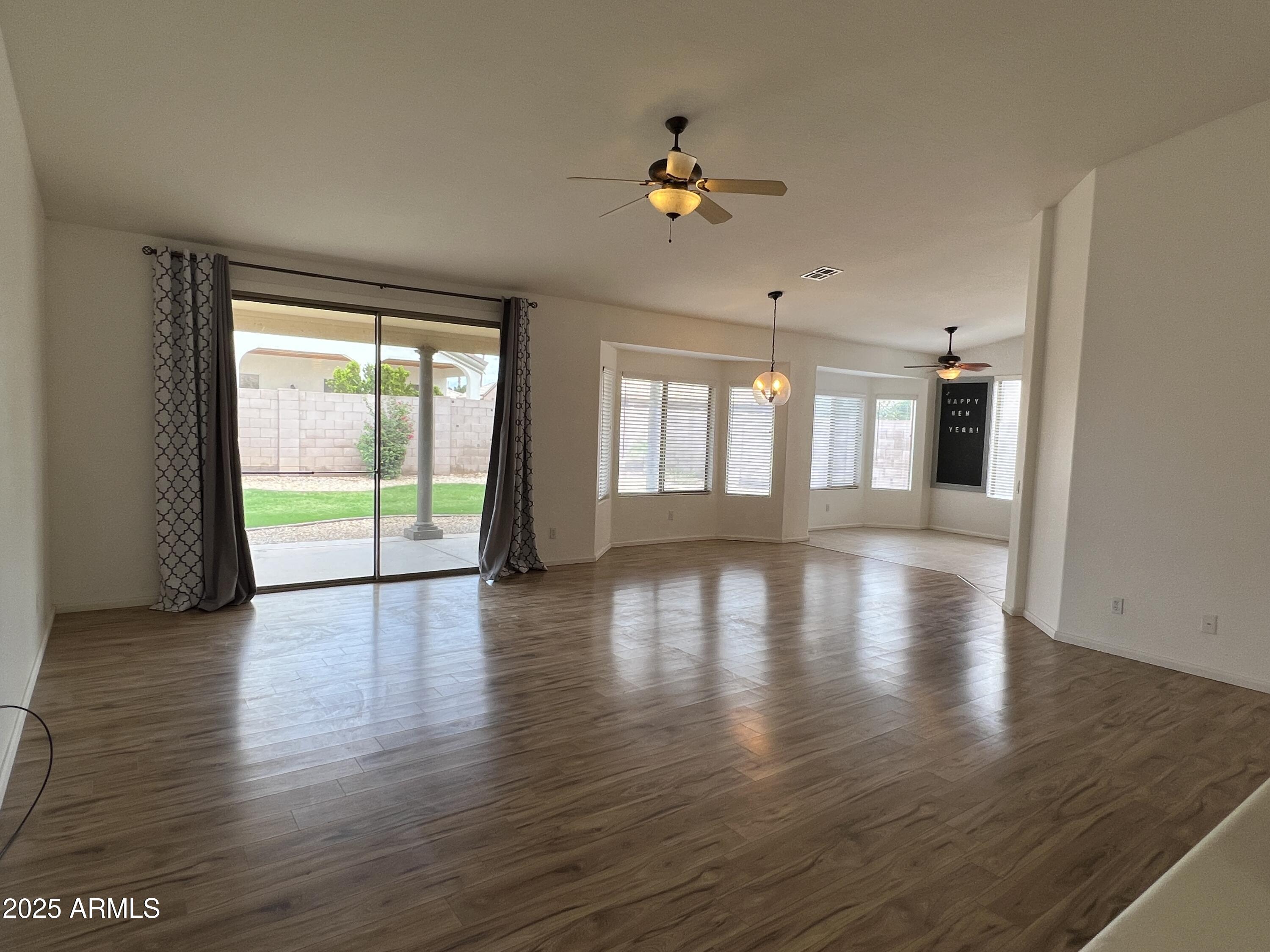 4484 East Redfield Court Gilbert, AZ 85234 - Photo 9 of 25 a view of an empty room with wooden floor and a window