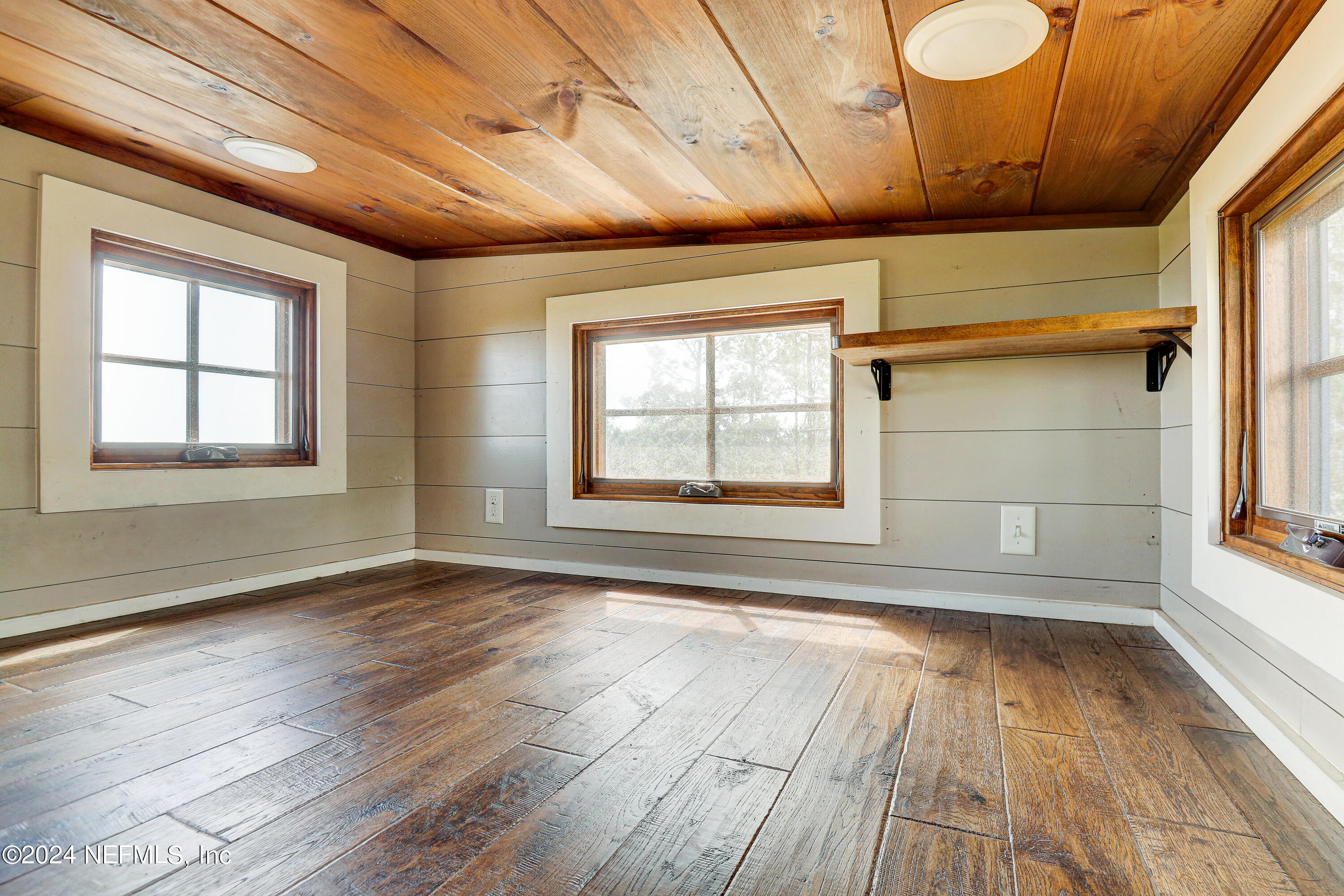 15649 Shellcracker Road Jacksonville, FL 32226 - Photo 17 of 35 an empty room with wooden floor and windows