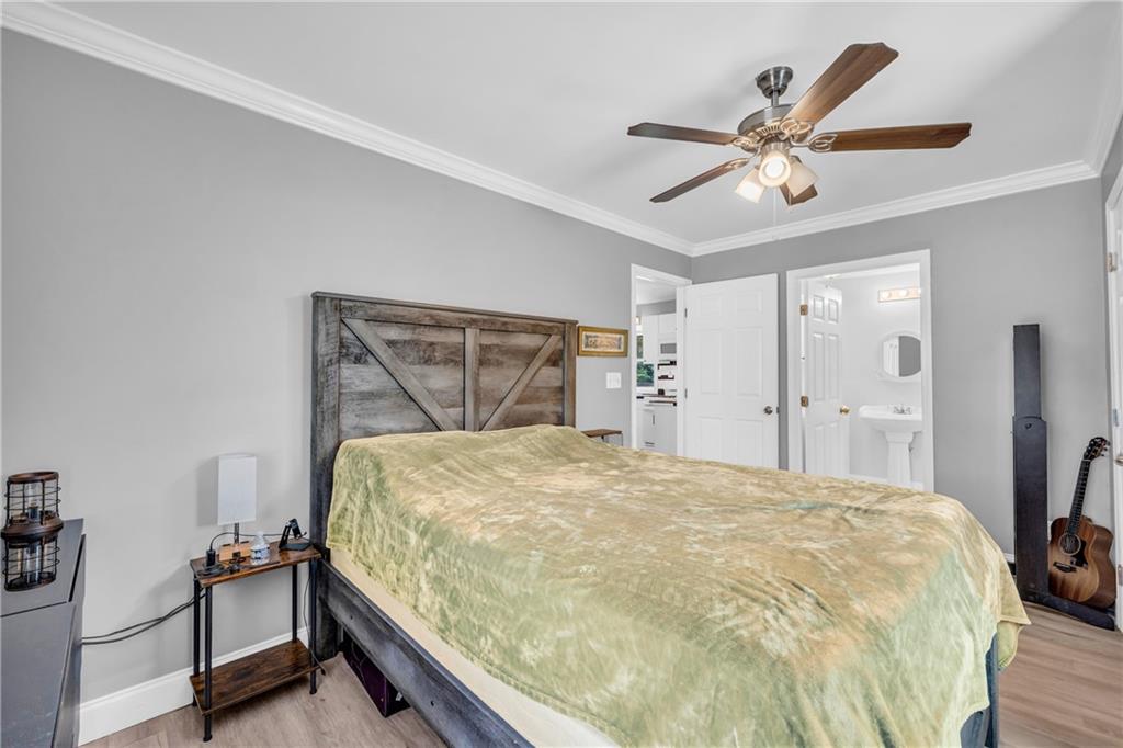 3351 Phillip Circle Decatur, GA 30032 - Photo 16 of 29 a bedroom with a bed and a chandelier