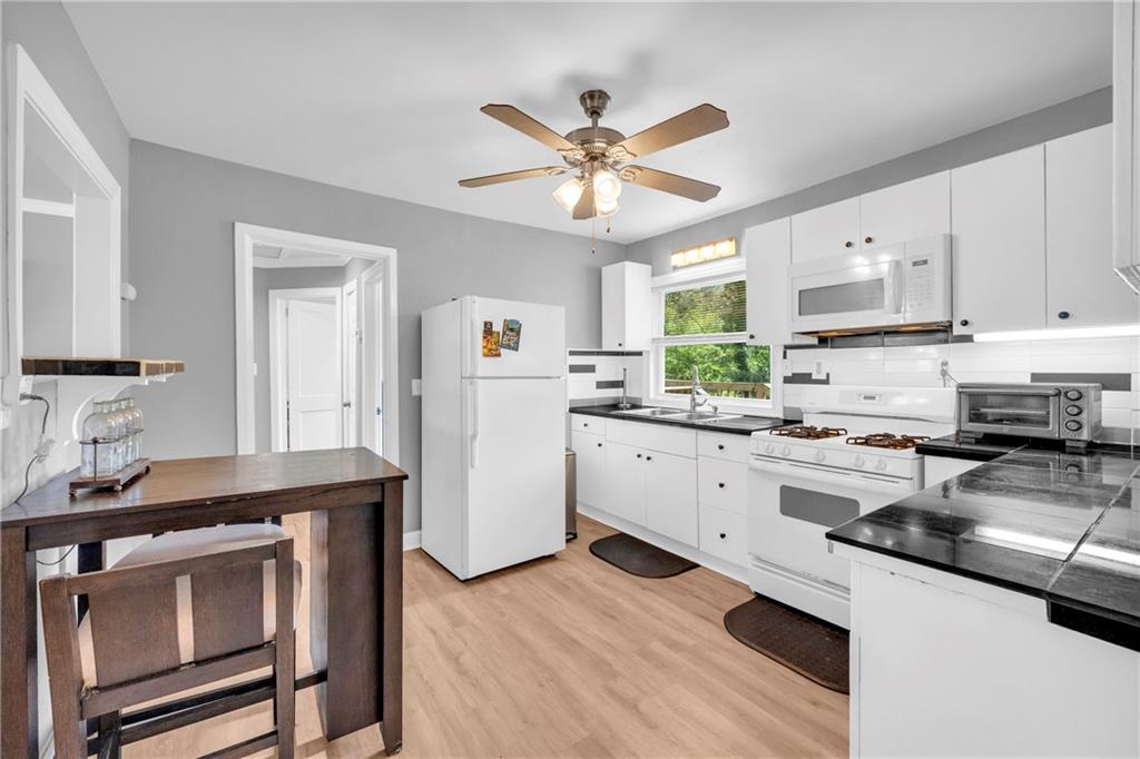 3351 Phillip Circle Decatur, GA 30032 - Photo 6 of 29 a kitchen with white cabinets and white appliances