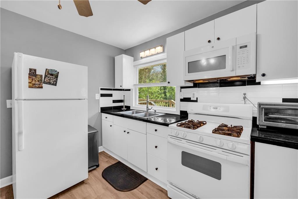 3351 Phillip Circle Decatur, GA 30032 - Photo 10 of 29 a kitchen with white cabinets and white appliances