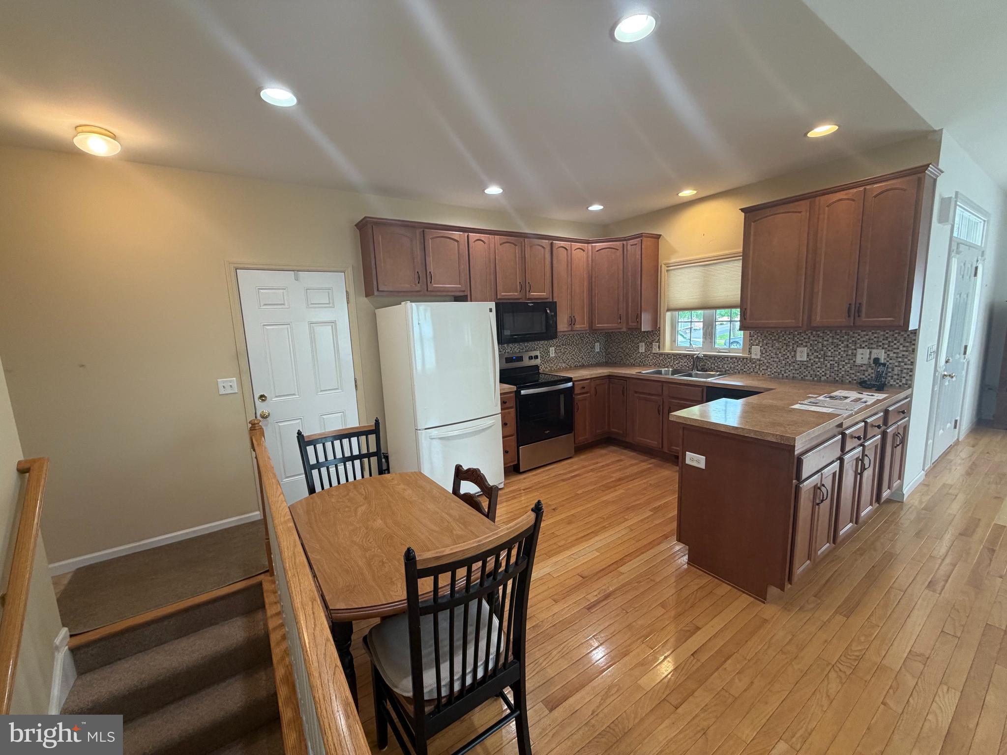 428 Haymarket Lane Lititz, PA 17543 - Photo 7 of 31 a kitchen with sink refrigerator and wooden cabinets