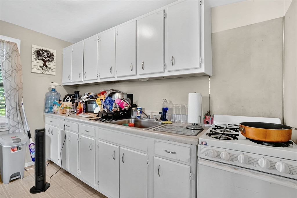 1440-1446 Carew Street Springfield, MA 01104 - Photo 12 of 26 a kitchen with a sink and cabinets