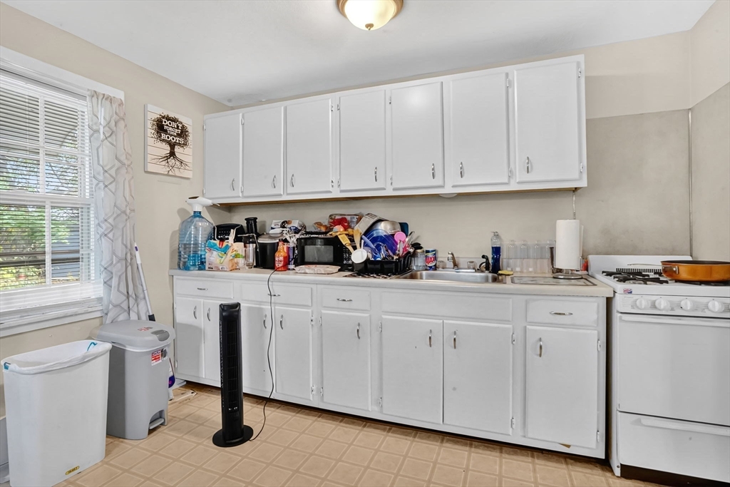 1440-1446 Carew Street Springfield, MA 01104 - Photo 13 of 26 a kitchen with white cabinets and sink