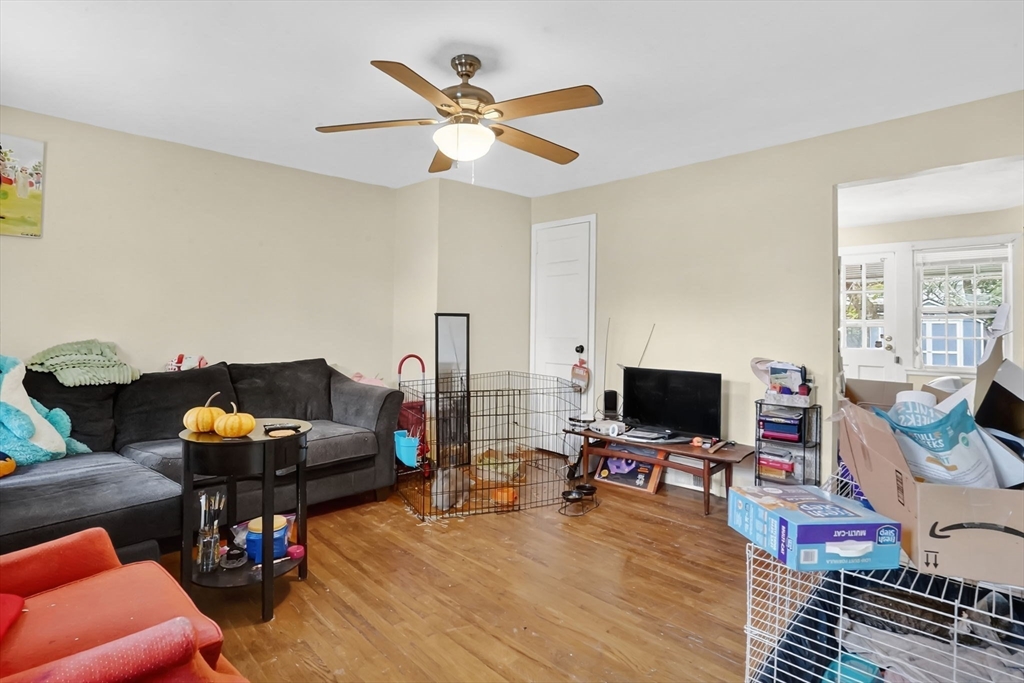 1440-1446 Carew Street Springfield, MA 01104 - Photo 14 of 26 a living room with furniture and a flat screen tv with wooden floor