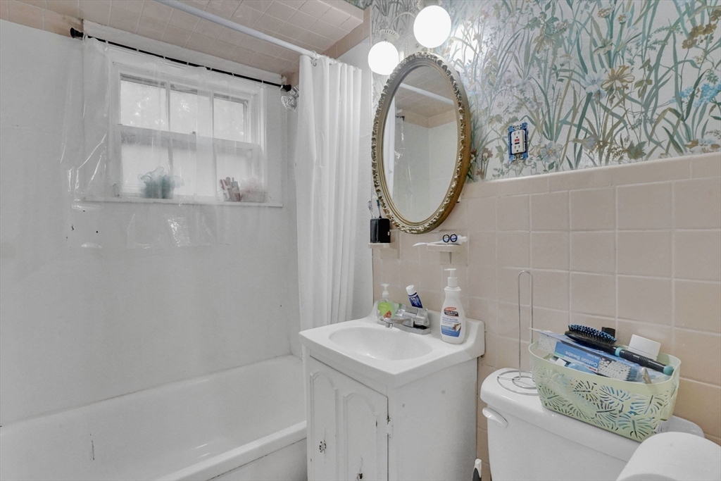 1440-1446 Carew Street Springfield, MA 01104 - Photo 19 of 26 a bathroom with a sink and a mirror