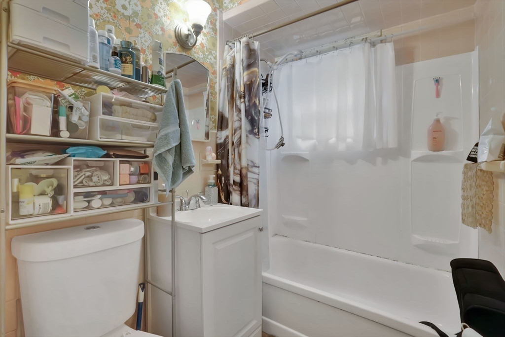 1440-1446 Carew Street Springfield, MA 01104 - Photo 23 of 26 a bathroom with a sink a toilet and shower