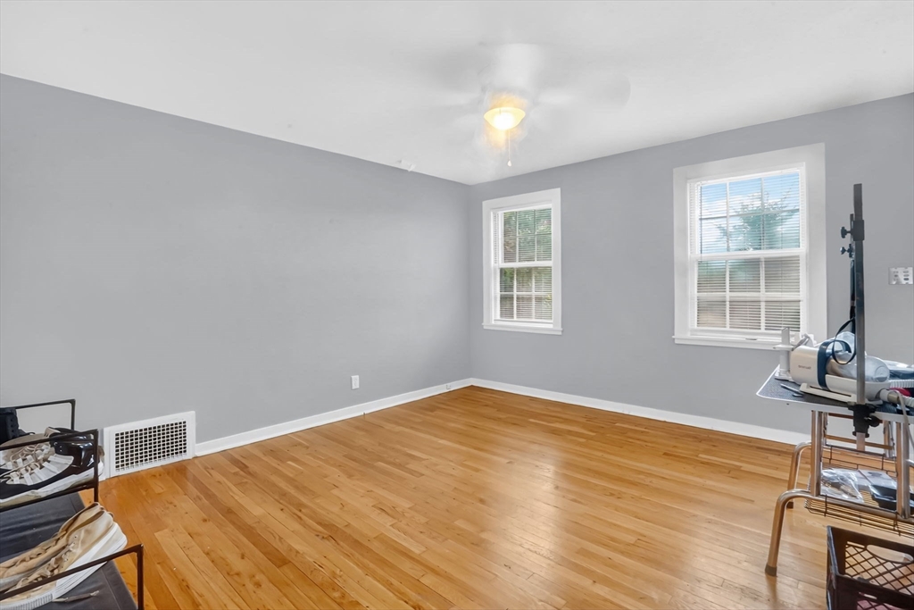 1440-1446 Carew Street Springfield, MA 01104 - Photo 9 of 26 a view of a room with wooden floor and windows