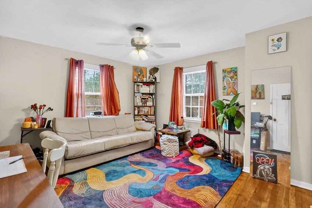 1440-1446 Carew Street Springfield, MA 01104 - Photo 10 of 26 a living room filled with furniture and a potted plant