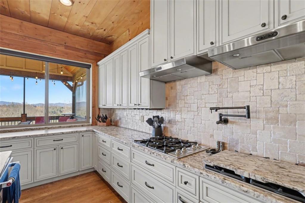 899 Ridge Pointe Way Blairsville, GA 30512 - Photo 20 of 88 a kitchen with a stove a sink a refrigerator and window