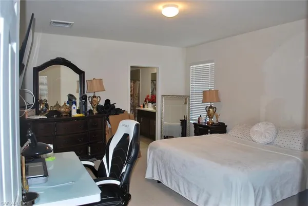 a bedroom with a bed and a chair