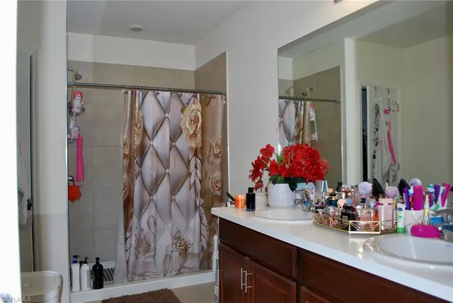 a bathroom with a sink vanity and a mirror