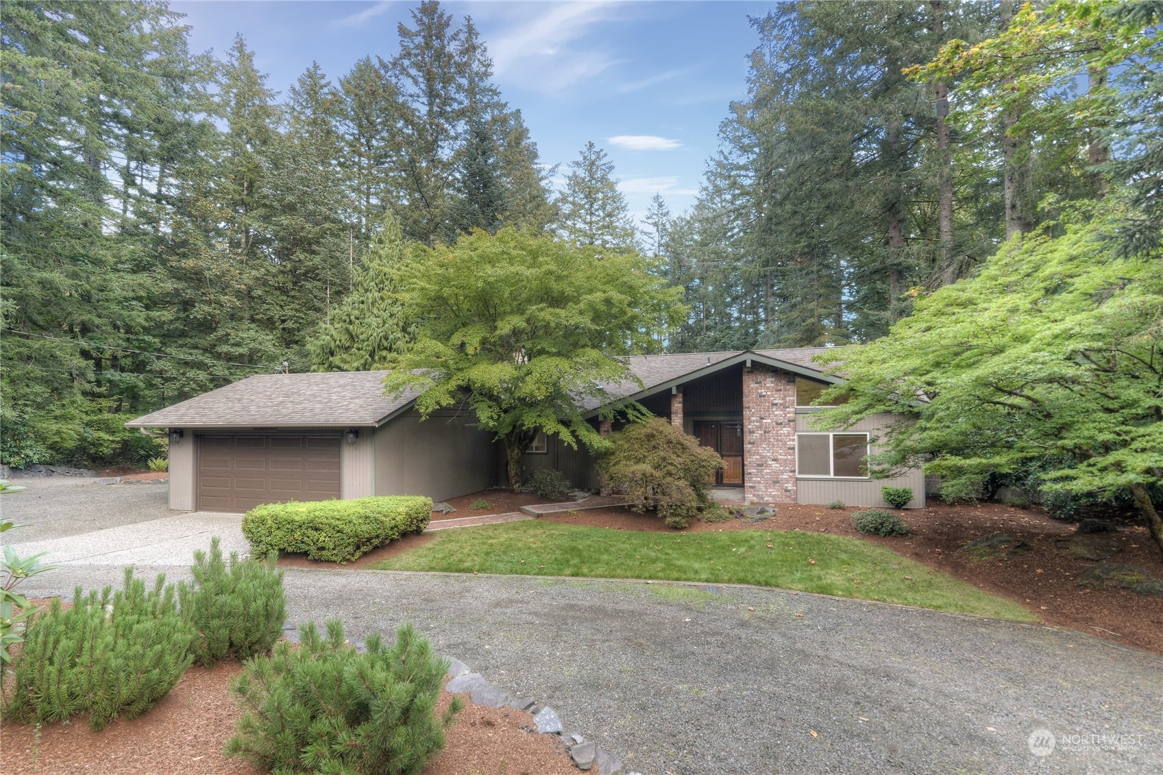 6120 Delphi Road Southwest Olympia, WA 98512 - Photo 1 of 40 a view of a yard in front of a house with large windows