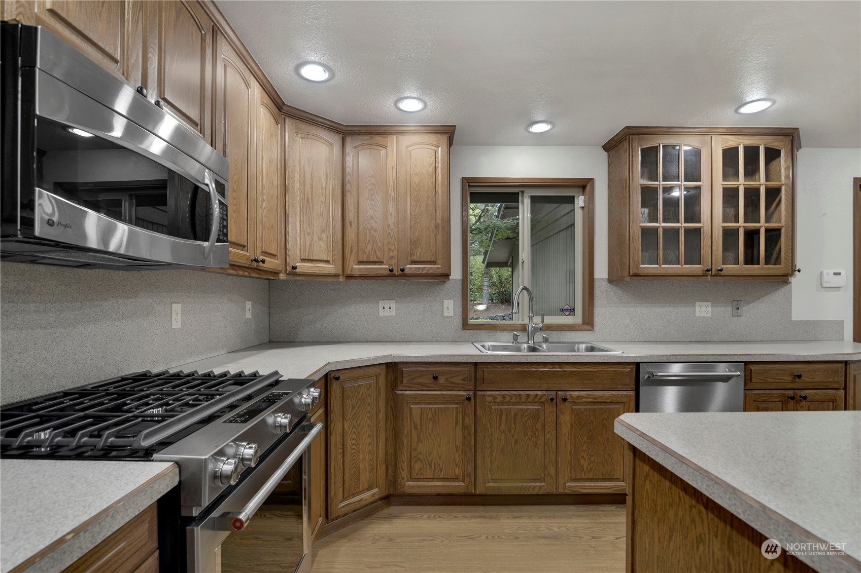 6120 Delphi Road Southwest Olympia, WA 98512 - Photo 12 of 40 a kitchen with stainless steel appliances granite countertop a stove and a sink