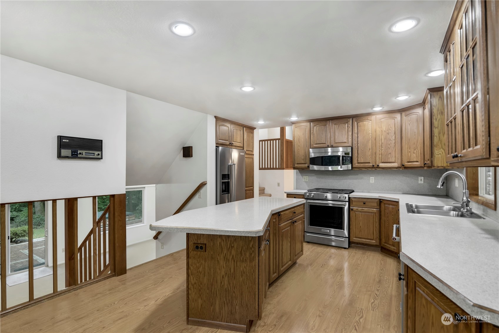6120 Delphi Road Southwest Olympia, WA 98512 - Photo 14 of 40 a kitchen with kitchen island granite countertop a stove top oven a sink a counter top space and cabinets