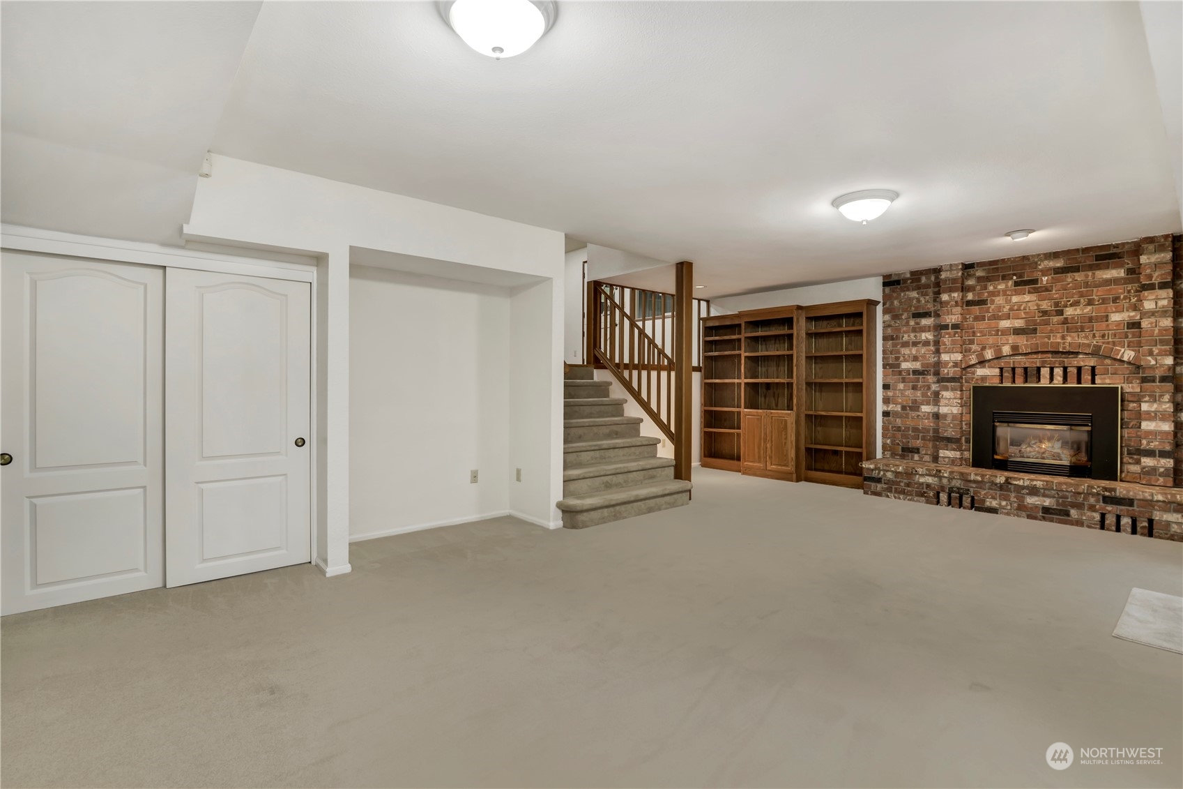 6120 Delphi Road Southwest Olympia, WA 98512 - Photo 26 of 40 a view of an empty room with a fireplace and stairs