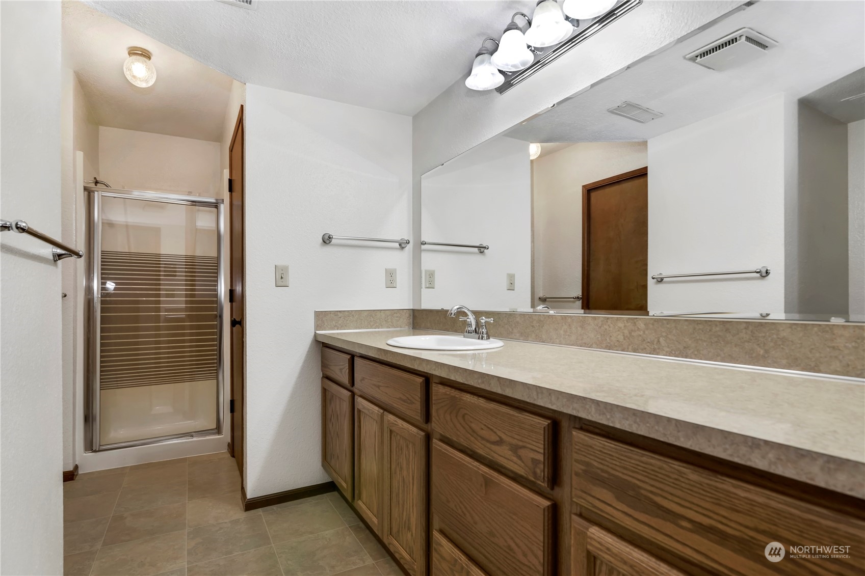 6120 Delphi Road Southwest Olympia, WA 98512 - Photo 29 of 40 a bathroom with a sink a mirror and a shower