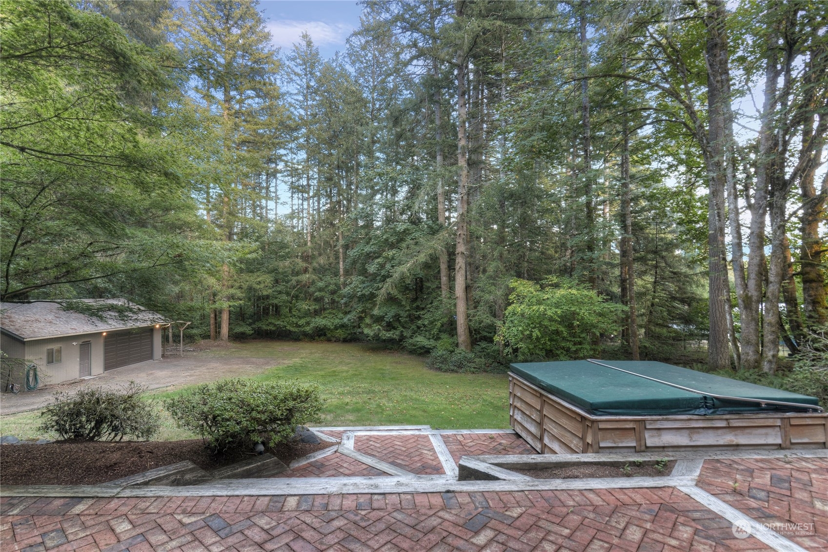 6120 Delphi Road Southwest Olympia, WA 98512 - Photo 36 of 40 a view of a backyard with potted plants and large trees